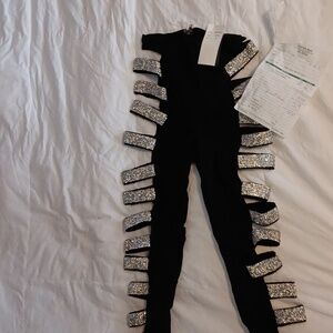 Black performing leggings with side sequence and zipper in the back.